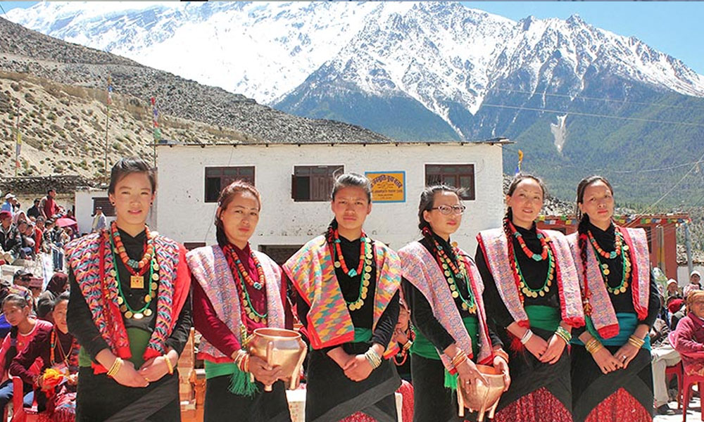 Thakali Women clad in their traditional Thakali attires welcome tourists on the occasion of 12 year festival in Gharpojhang Rural Municipality in Mustang district