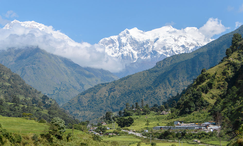 Green valleys and snow-covered peaks along the Annapurna Circuit—it is evident in September during the post-monsoon trekking season