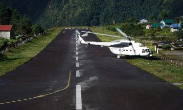 helicopter landing on runway at tenzing