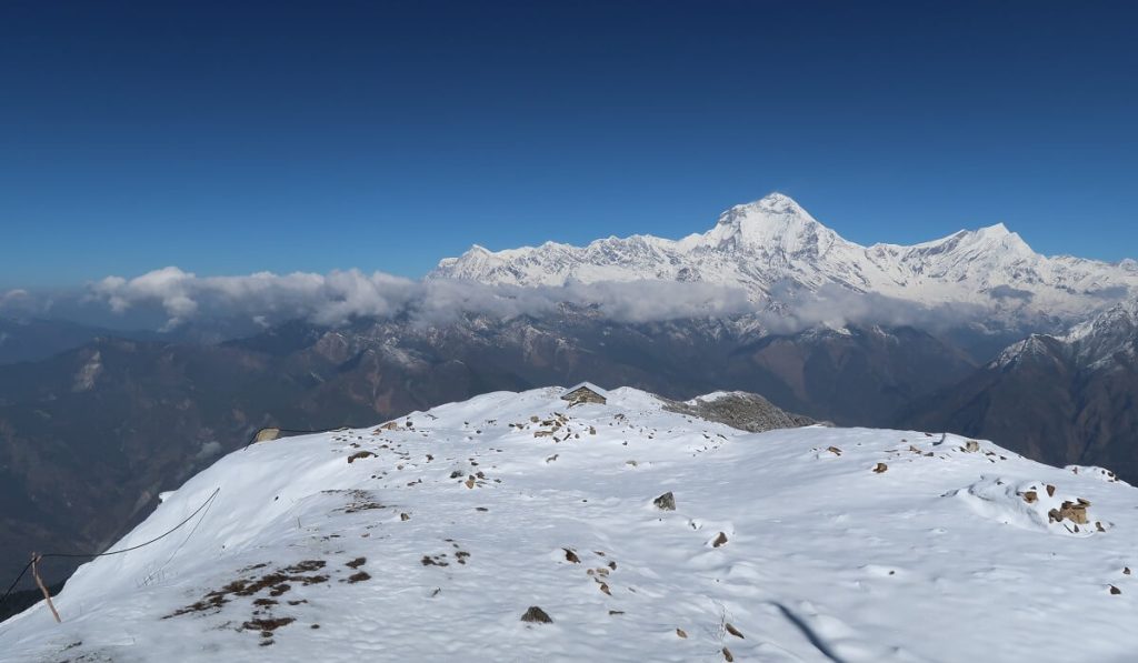 Snow-covered Himalayan mountains under clear blue skies in Nepal