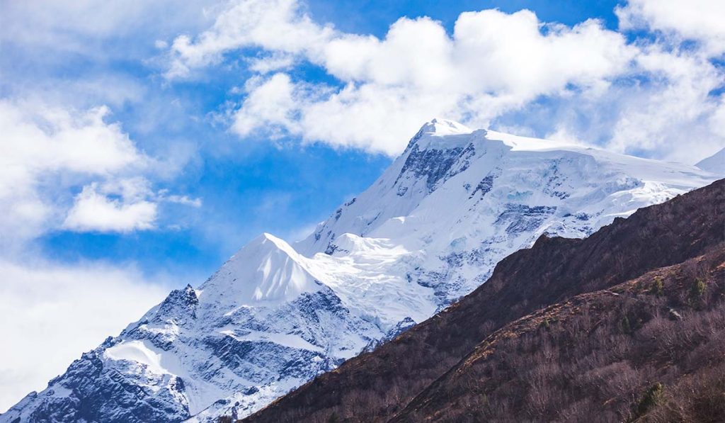 Snow-covered peaks and clear spring skies in the Annapurna region during May trekking season.