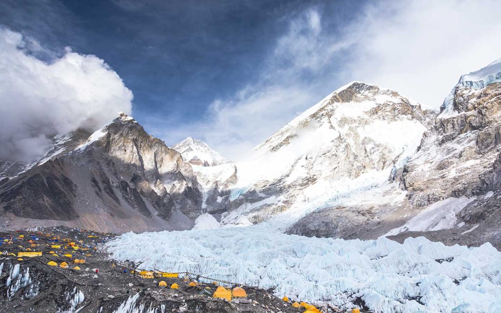 Spectacular view of yellow expedition tents and the Khumbu Icefall, the final destination on the Everest Base Camp Trek by Road.